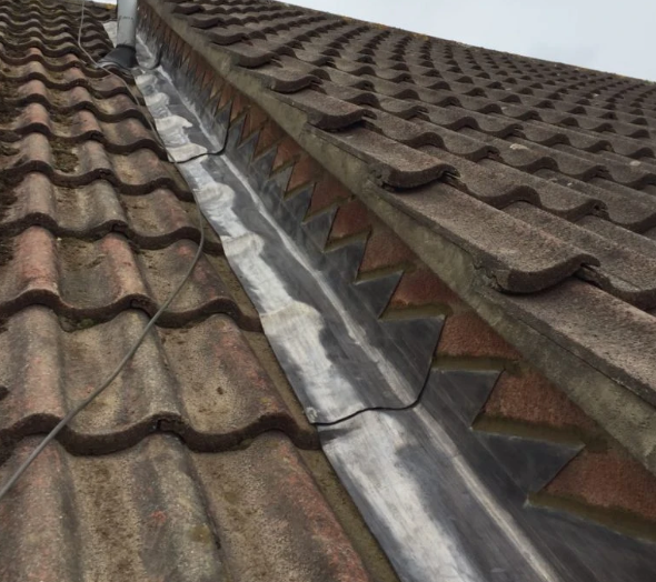 Lead valley repair between tiled roof slopes
